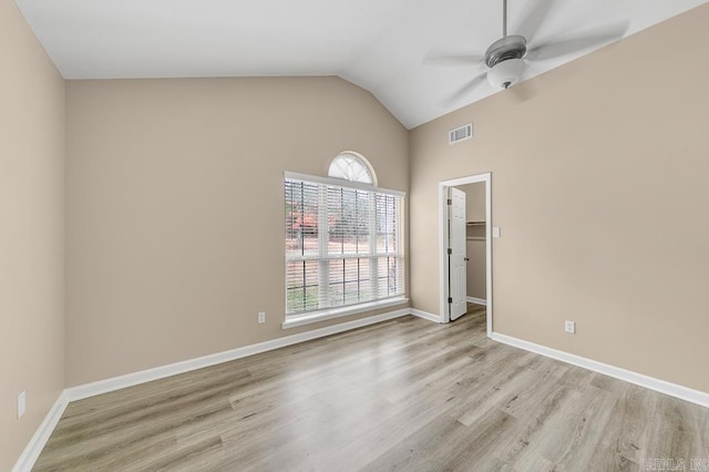 unfurnished room featuring lofted ceiling, ceiling fan, and light wood-type flooring