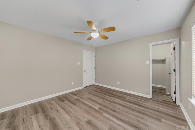 empty room featuring ceiling fan and light hardwood / wood-style flooring