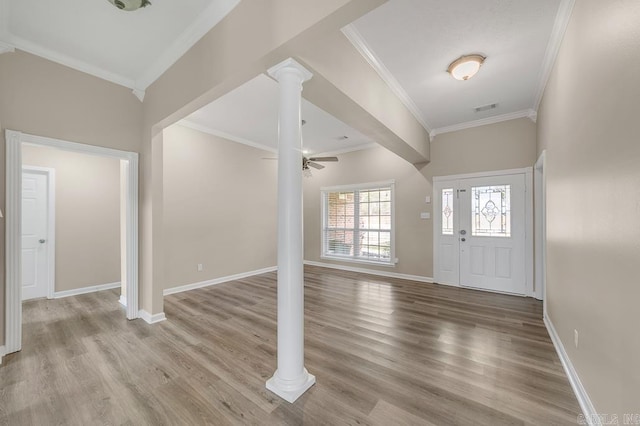 entryway with light hardwood / wood-style floors, ornate columns, ceiling fan, and ornamental molding