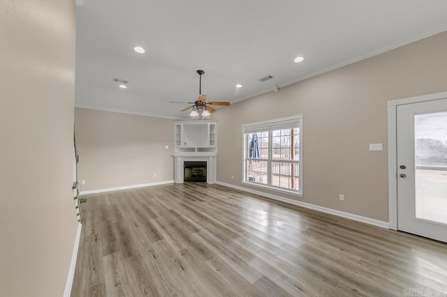 unfurnished living room featuring ceiling fan, light hardwood / wood-style flooring, and ornamental molding