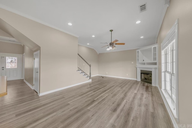 unfurnished living room with light wood-type flooring, ceiling fan, and ornamental molding