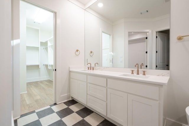 bathroom with vanity and ornamental molding