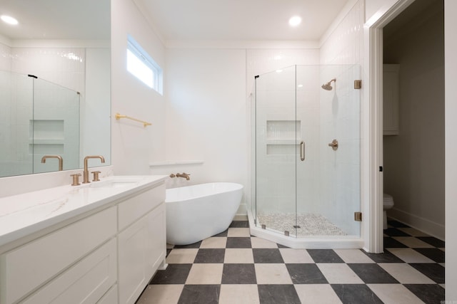 bathroom featuring shower with separate bathtub and vanity