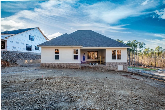 back of house with ceiling fan