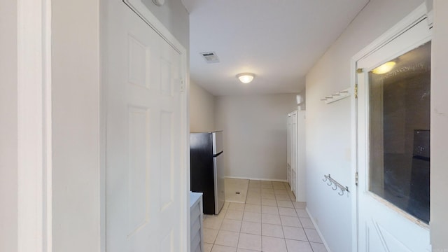 hallway featuring light tile patterned floors