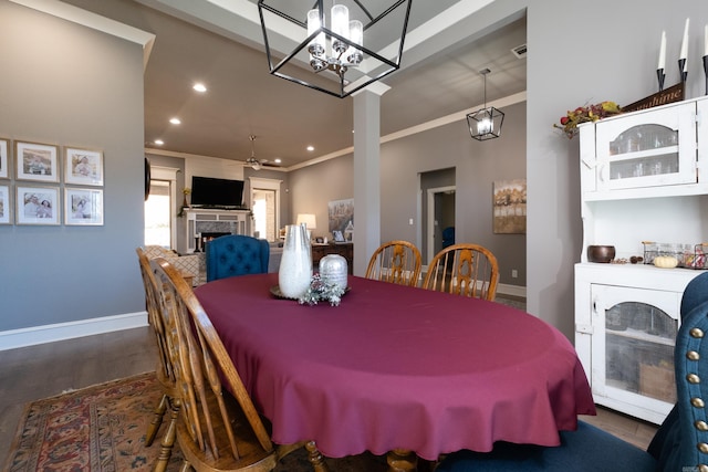 dining area with ceiling fan, dark hardwood / wood-style floors, and crown molding