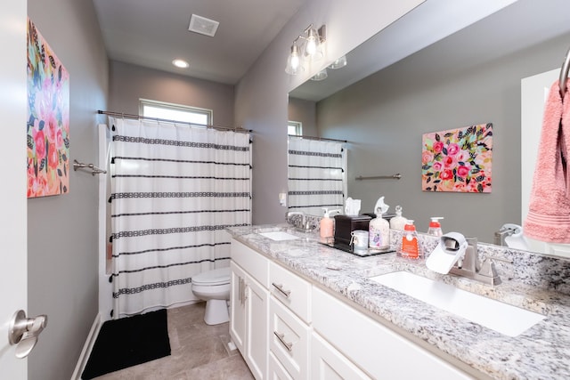 bathroom with curtained shower, tile patterned flooring, vanity, and toilet