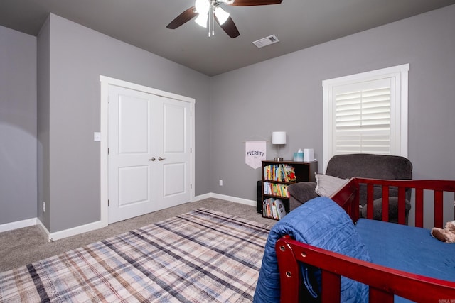 bedroom with carpet flooring, ceiling fan, and a closet