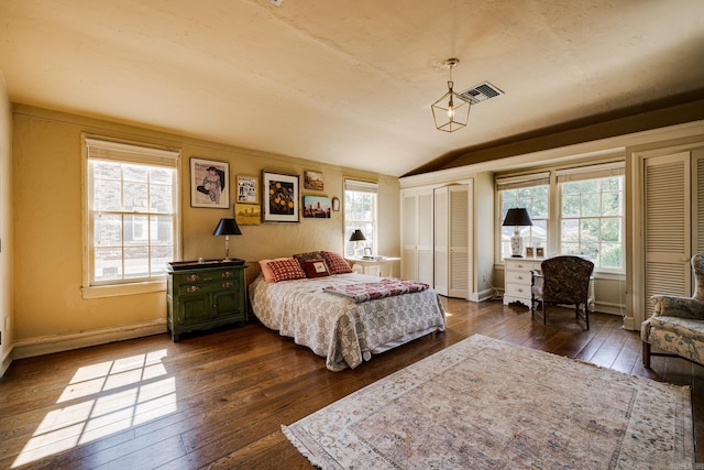 bedroom with dark hardwood / wood-style flooring and vaulted ceiling