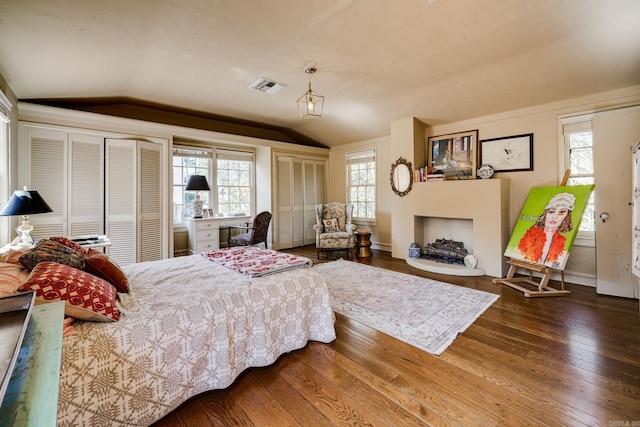 bedroom with hardwood / wood-style floors and vaulted ceiling