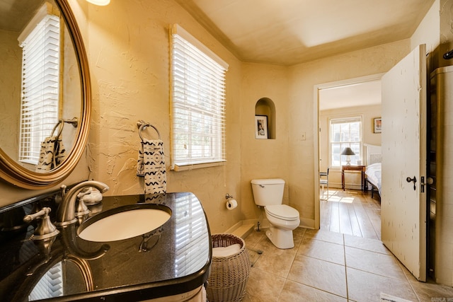 bathroom with tile patterned floors, sink, and toilet