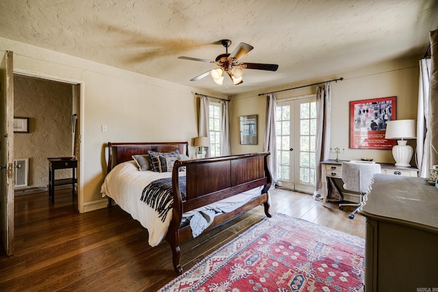 bedroom featuring french doors, ceiling fan, dark hardwood / wood-style floors, access to exterior, and a textured ceiling