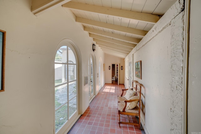 hallway featuring tile patterned flooring, french doors, vaulted ceiling with beams, and wood ceiling