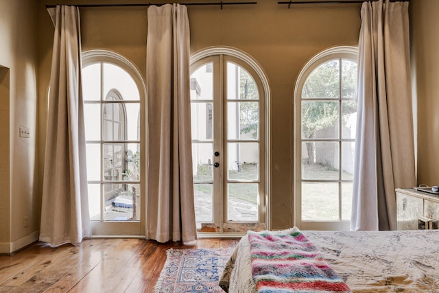 bedroom with light wood-type flooring and french doors