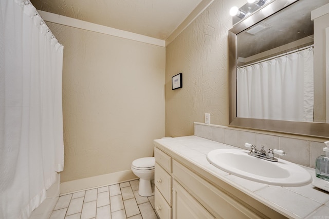 bathroom with backsplash, vanity, crown molding, toilet, and curtained shower