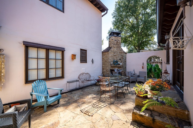 view of patio featuring an outdoor stone fireplace