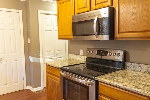 kitchen featuring light stone countertops and appliances with stainless steel finishes