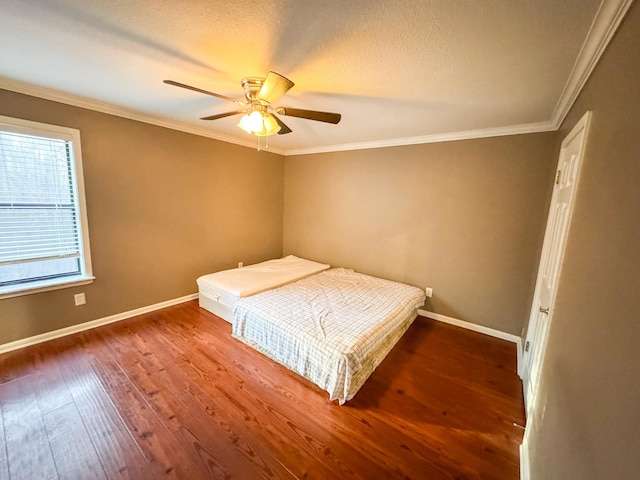 unfurnished bedroom with hardwood / wood-style flooring, ceiling fan, and ornamental molding