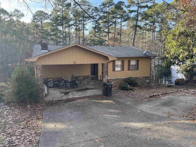 ranch-style house featuring a carport