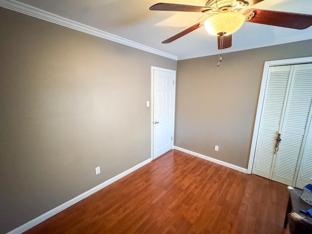 unfurnished bedroom with a closet, ceiling fan, hardwood / wood-style floors, and ornamental molding