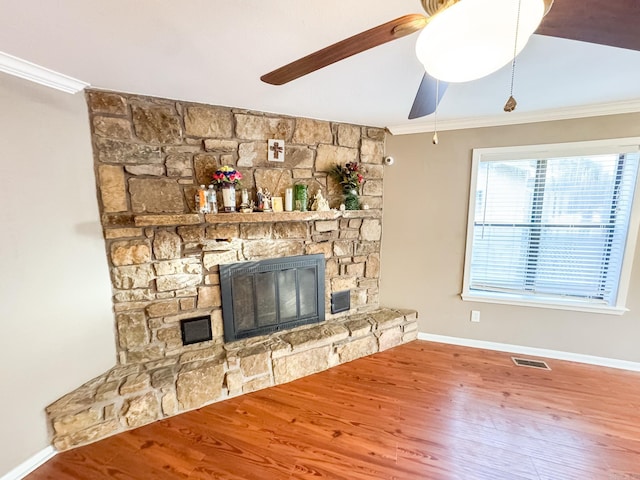 unfurnished living room featuring crown molding, hardwood / wood-style flooring, a fireplace, and ceiling fan