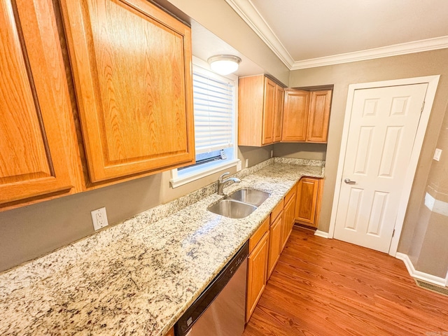 kitchen featuring light stone countertops, hardwood / wood-style floors, sink, stainless steel dishwasher, and crown molding