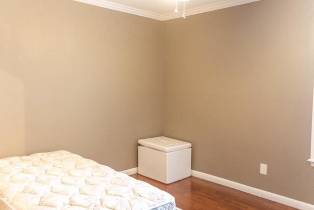 unfurnished bedroom with hardwood / wood-style flooring and ornamental molding