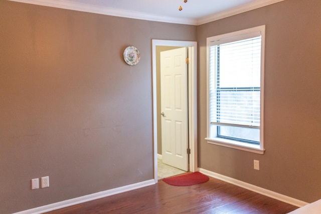 unfurnished room with crown molding, hardwood / wood-style floors, and plenty of natural light