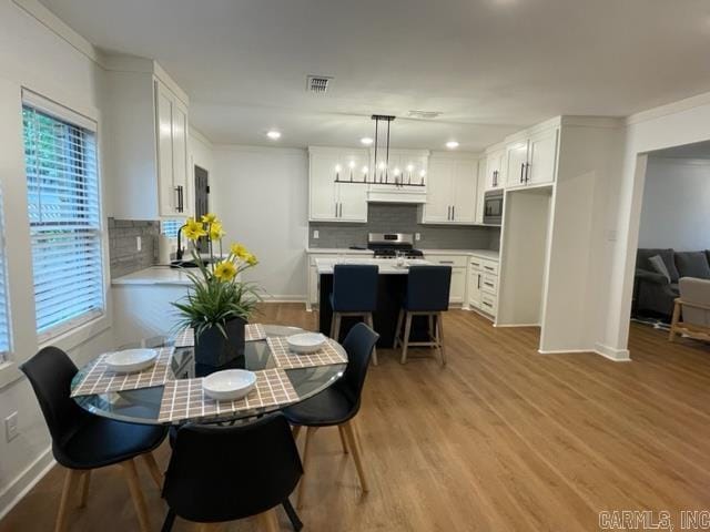 dining area featuring a chandelier and light hardwood / wood-style floors