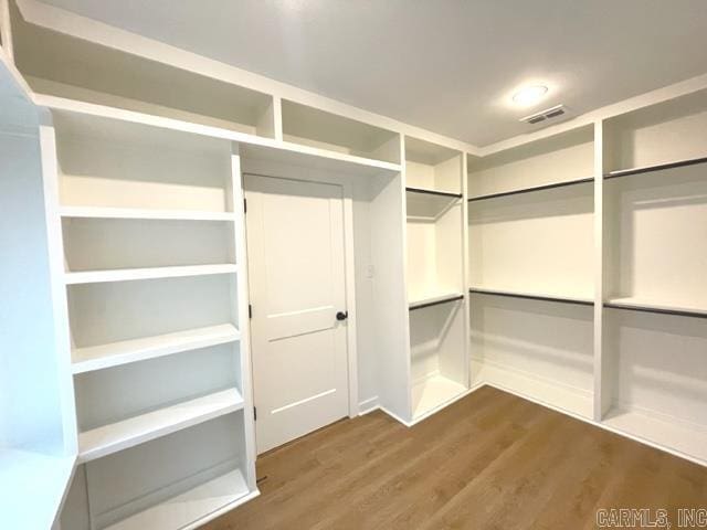 walk in closet featuring dark hardwood / wood-style floors