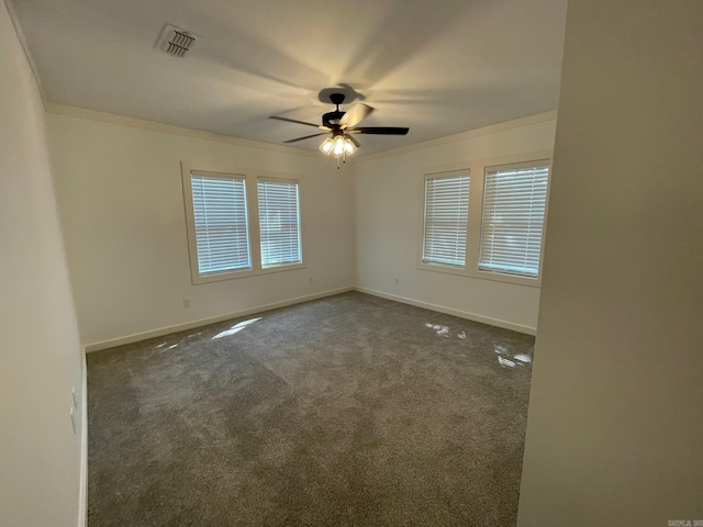 carpeted empty room featuring plenty of natural light, ceiling fan, and crown molding