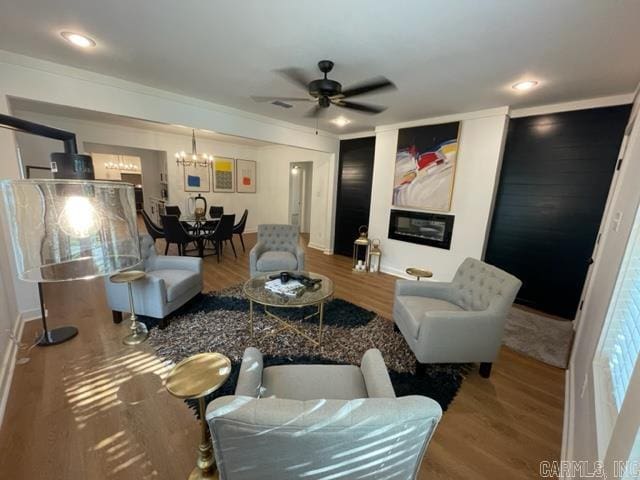 living room featuring hardwood / wood-style floors and ceiling fan with notable chandelier