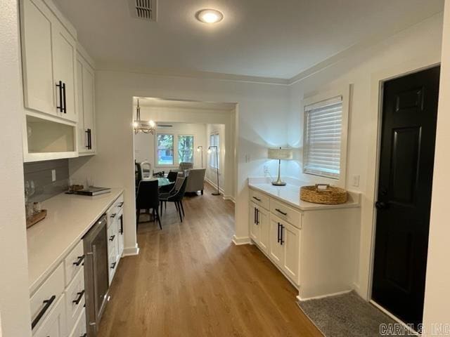 kitchen with white cabinetry and wood-type flooring