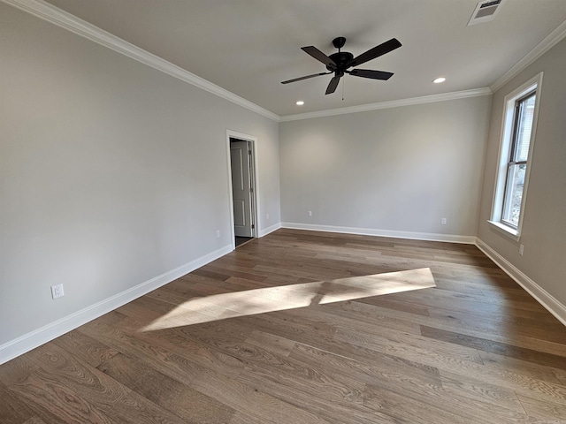 spare room featuring hardwood / wood-style flooring, ceiling fan, and crown molding