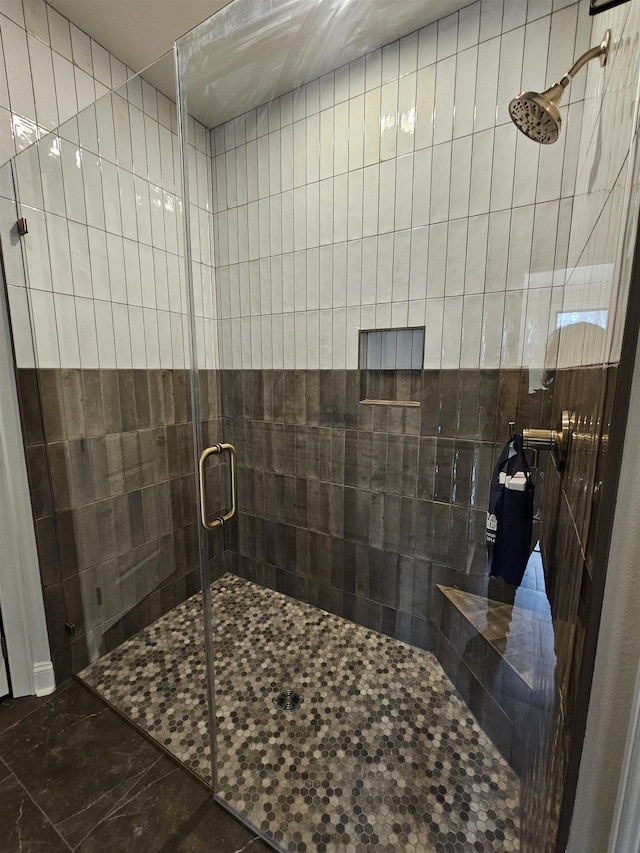 bathroom featuring a shower with door