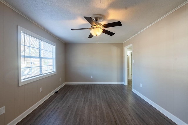 empty room with ceiling fan, dark wood-type flooring, a textured ceiling, and ornamental molding