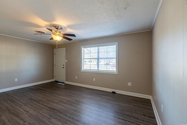 spare room featuring ceiling fan, dark hardwood / wood-style flooring, ornamental molding, and a textured ceiling