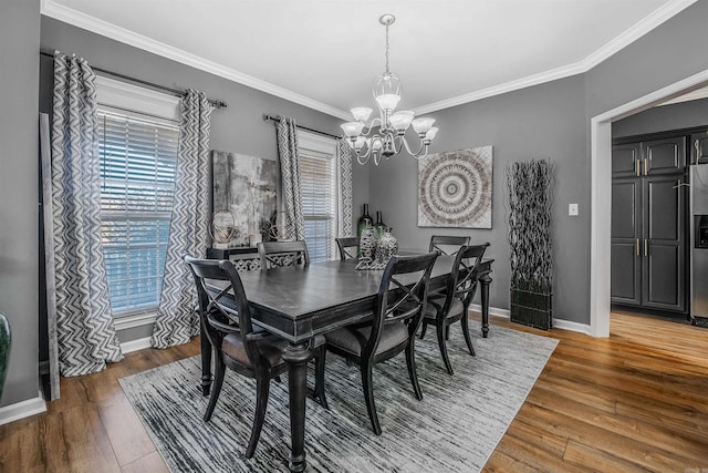 dining space featuring a notable chandelier, wood-type flooring, and ornamental molding