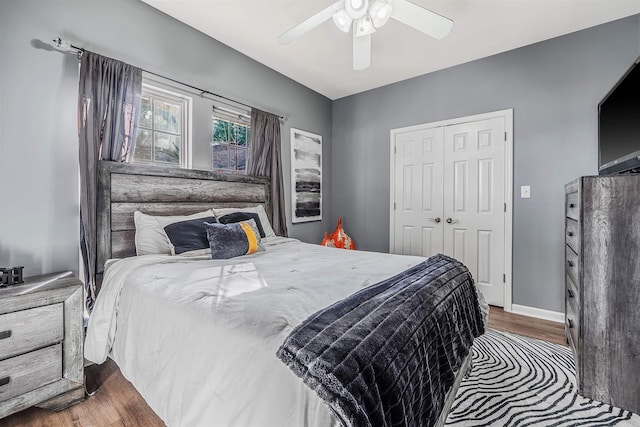 bedroom with ceiling fan, a closet, and hardwood / wood-style flooring