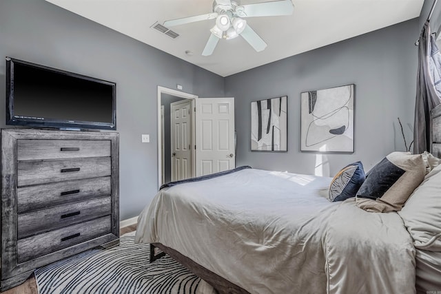 bedroom with hardwood / wood-style floors and ceiling fan