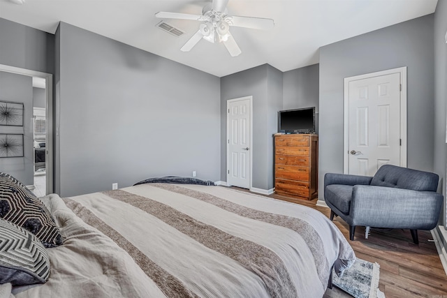 bedroom with hardwood / wood-style flooring and ceiling fan