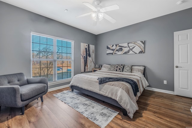 bedroom with ceiling fan and hardwood / wood-style floors