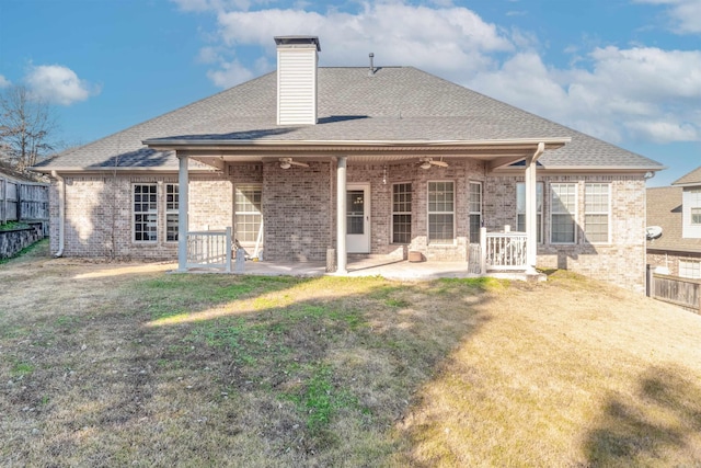 back of property with a lawn, ceiling fan, and a patio area