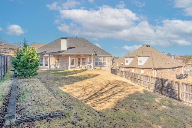 back of house featuring a yard