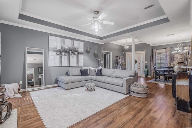 living room featuring a tray ceiling and hardwood / wood-style floors