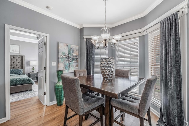 dining area with hardwood / wood-style flooring, plenty of natural light, and crown molding