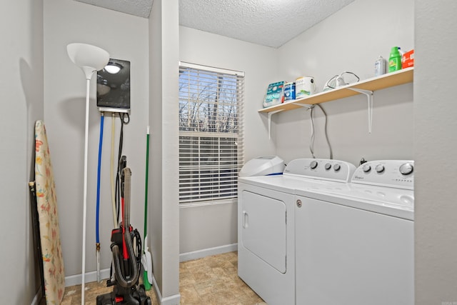 washroom featuring separate washer and dryer and a textured ceiling