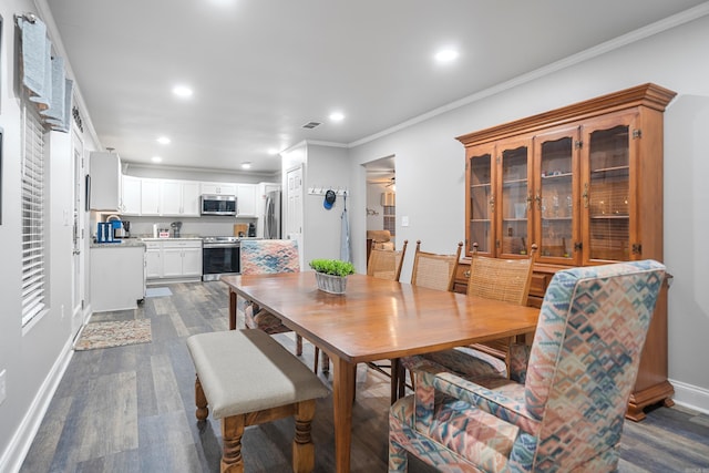 dining room featuring crown molding and dark hardwood / wood-style floors