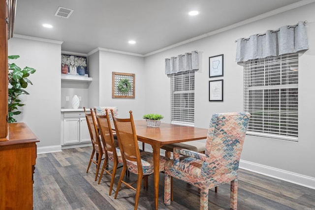 dining room featuring dark hardwood / wood-style flooring and crown molding