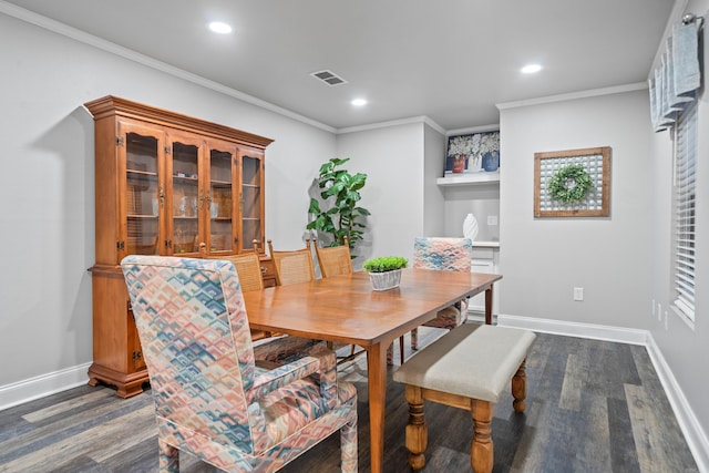 dining area featuring dark hardwood / wood-style flooring and ornamental molding